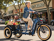 A single rider navigating alone with absolute confidence on a stable three wheel electric trike.