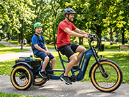 A reliable tandem trike equipped with a protective rear backrest providing a supportive ride for individuals with limited mobility.